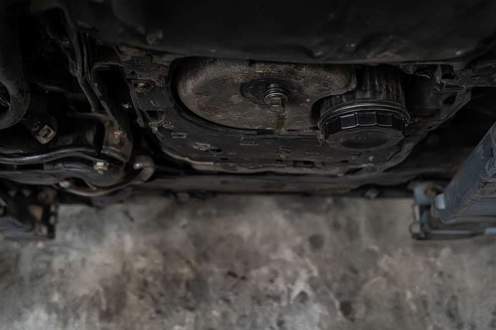 Oil drain under a car on a lift